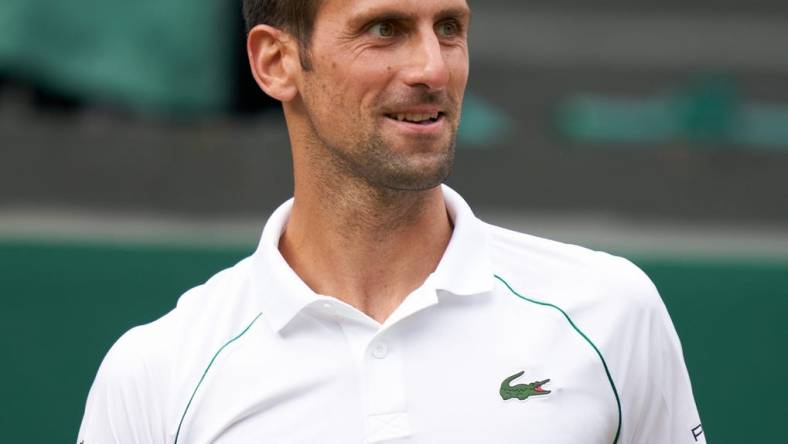 Jul 11, 2021; London, United Kingdom; Novak Djokovic (SRB) smiling while playing against Matteo Berrettini (ITA) in the men s final on Centre Court at All England Lawn Tennis and Croquet Club. Mandatory Credit: Peter van den Berg-USA TODAY Sports