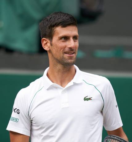 Jul 11, 2021; London, United Kingdom; Novak Djokovic (SRB) smiling while playing against Matteo Berrettini (ITA) in the men s final on Centre Court at All England Lawn Tennis and Croquet Club. Mandatory Credit: Peter van den Berg-USA TODAY Sports