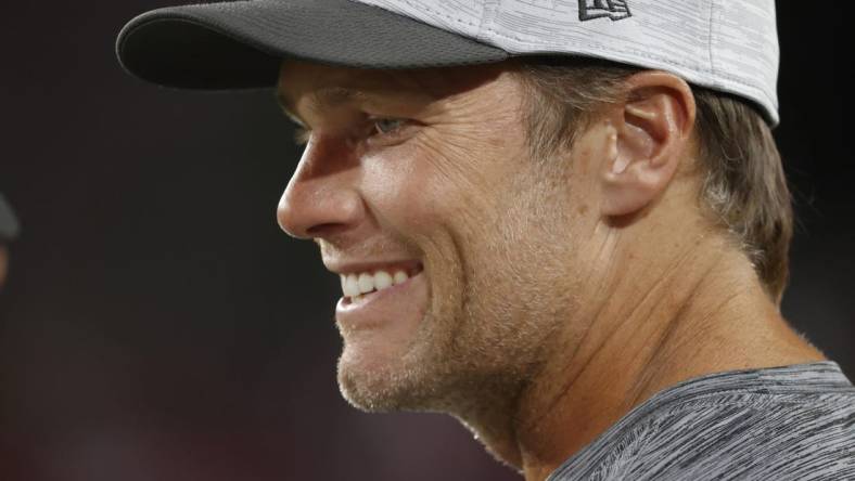 Aug 21, 2021; Tampa, Florida, USA; Tampa Bay Buccaneers quarterback Tom Brady (12) smiles on the sidelines during the second quarter against the Tennessee Titans at Raymond James Stadium. Mandatory Credit: Kim Klement-USA TODAY Sports