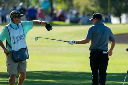 Nov 12, 2021; Phoenix, Arizona, USA; Steven Alker (right) and caddy Sam Workman (left) trade out clubs after hitting to the green of the ninth during the second round of the Charles Schwab Cup Championship golf tournament at Phoenix Country Club. Mandatory Credit: Allan Henry-USA TODAY Sports