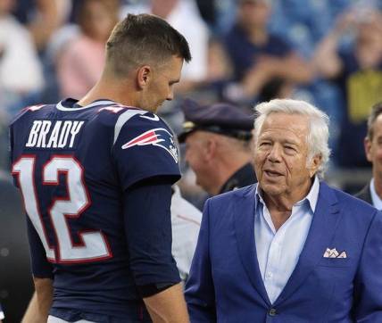 Tom Brady talks with owner Robert Kraft before a preseason game in August 2019.