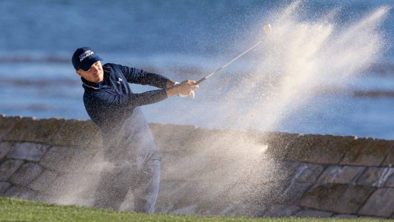 Feb 6, 2022; Pebble Beach, California, USA; Jordan Spieth plays a shot from a bunker on the 18th hole during the final round of the AT&T Pebble Beach Pro-Am golf tournament at Pebble Beach Golf Links. Mandatory Credit: Bill Streicher-USA TODAY Sports