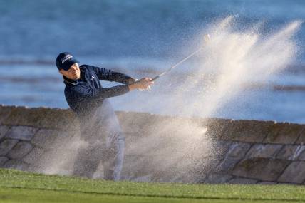 Feb 6, 2022; Pebble Beach, California, USA; Jordan Spieth plays a shot from a bunker on the 18th hole during the final round of the AT&T Pebble Beach Pro-Am golf tournament at Pebble Beach Golf Links. Mandatory Credit: Bill Streicher-USA TODAY Sports