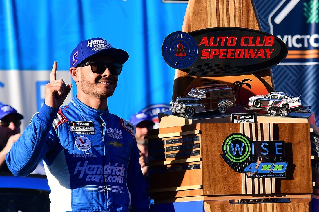 Feb 27, 2022; Fontana, California, USA; NASCAR Cup Series driver Kyle Larson (5) celebrates his victory of the WISE Power 400 at Auto Club Speedway. Mandatory Credit: Gary A. Vasquez-USA TODAY Sports