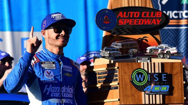 Feb 27, 2022; Fontana, California, USA; NASCAR Cup Series driver Kyle Larson (5) celebrates his victory of the WISE Power 400 at Auto Club Speedway. Mandatory Credit: Gary A. Vasquez-USA TODAY Sports