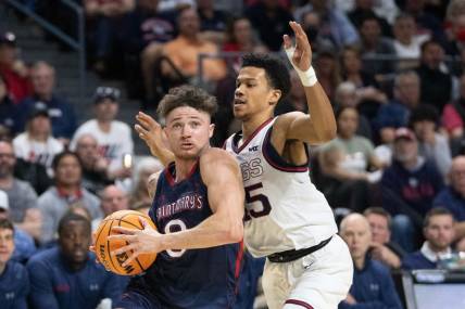 March 8, 2022; Las Vegas, NV, USA; Saint Mary's Gaels guard Logan Johnson (0) dribbles the basketball against Gonzaga Bulldogs guard Rasir Bolton (45) during the second half in the finals of the WCC Basketball Championships at Orleans Arena. Mandatory Credit: Kyle Terada-USA TODAY Sports