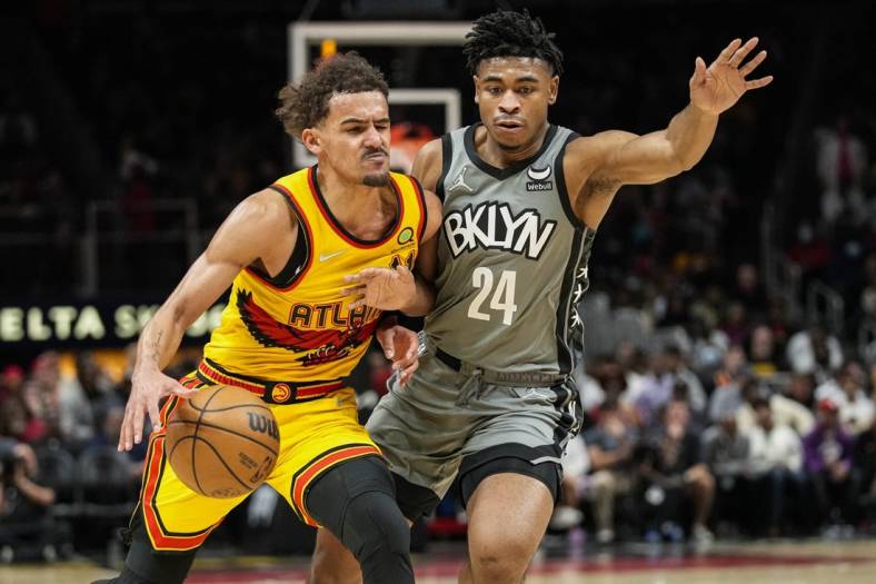 Apr 2, 2022; Atlanta, Georgia, USA; Atlanta Hawks guard Trae Young (11) is guarded by Brooklyn Nets guard Cam Thomas (24) during the second half at State Farm Arena. Mandatory Credit: Dale Zanine-USA TODAY Sports