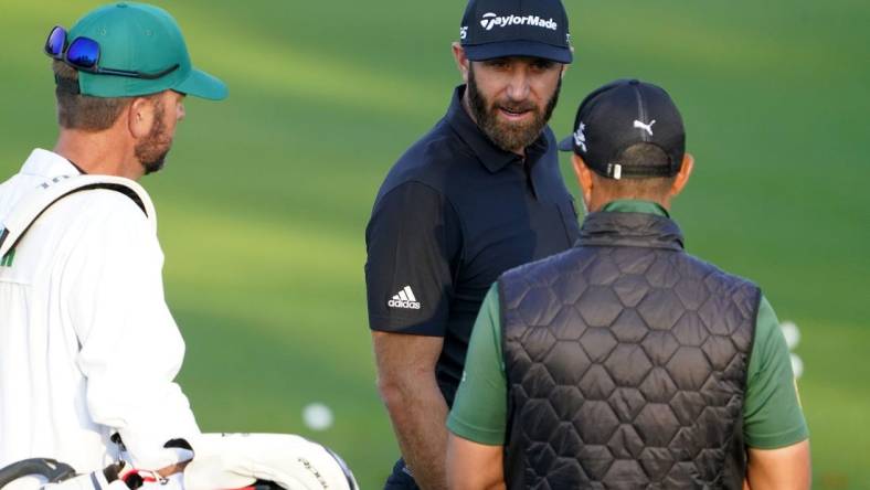 Apr 5, 2022; Augusta, Georgia, USA; Dustin Johnson hits at the practice facility during a practice round of The Masters golf tournament at Augusta National Golf Club. Mandatory Credit: Danielle Parhizkaran-Augusta Chronicle/USA TODAY Network

Golf Masters Tournament Practice Round