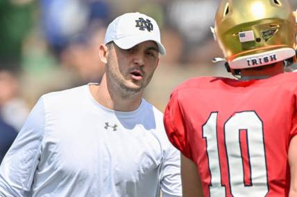 Apr 23, 2022; Notre Dame, Indiana, USA; Notre Dame Fighting Irish offensive coordinator Tommy Rees talks to quarterback Drew Pyne (10) during warmups before the Blue-Gold Game at Notre Dame Stadium. Mandatory Credit: Matt Cashore-USA TODAY Sports