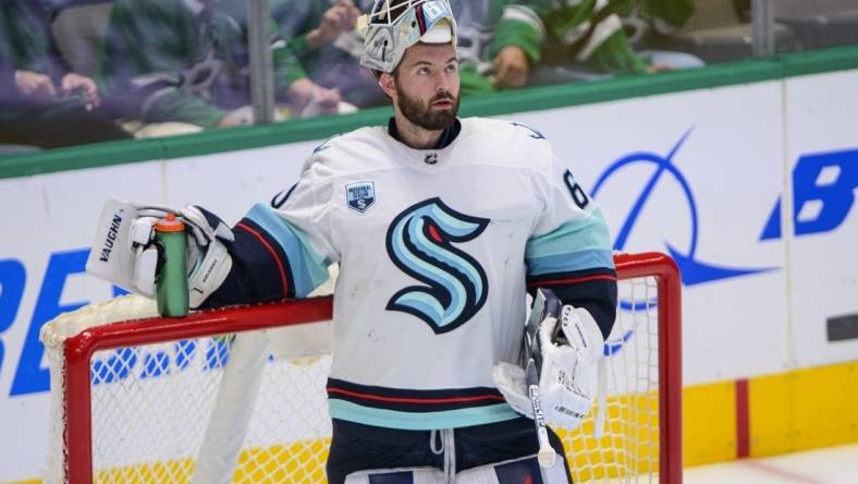 Apr 23, 2022; Dallas, Texas, USA; Seattle Kraken goaltender Chris Driedger (60) waits while the referees check a video review during the first period against the Dallas Stars at the American Airlines Center. Mandatory Credit: Jerome Miron-USA TODAY Sports