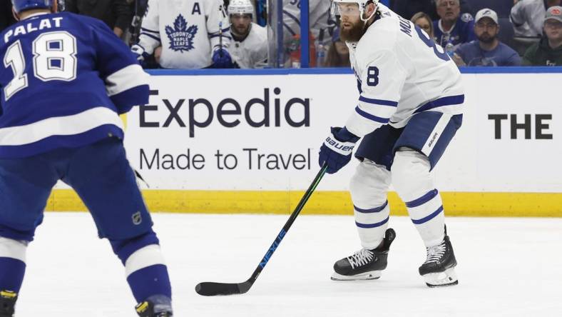 May 6, 2022; Tampa, Florida, USA;Toronto Maple Leafs defenseman Jake Muzzin (8) skates with the puck as Tampa Bay Lightning left wing Ondrej Palat (18) defends during the second period of game three of the first round of the 2022 Stanley Cup Playoffs against the Tampa Bay Lightning at Amalie Arena. Mandatory Credit: Kim Klement-USA TODAY Sports