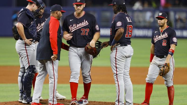 Jun 9, 2022; Miami, Florida, USA; Washington Nationals manager Dave Martinez (4) takes starting pitcher Stephen Strasburg (37) out of the game in the fifth inning against the Miami Marlins at loanDepot Park. Mandatory Credit: Sam Navarro-USA TODAY Sports