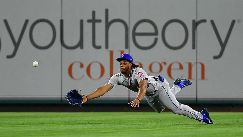 Jun 11, 2022; Anaheim, California, USA; New York Mets center fielder Khalil Lee (26) misses catching the two run RBI triple hit by Los Angeles Angels first baseman Jared Walsh (20) during the eighth inning at Angel Stadium. Mandatory Credit: Gary A. Vasquez-USA TODAY Sports