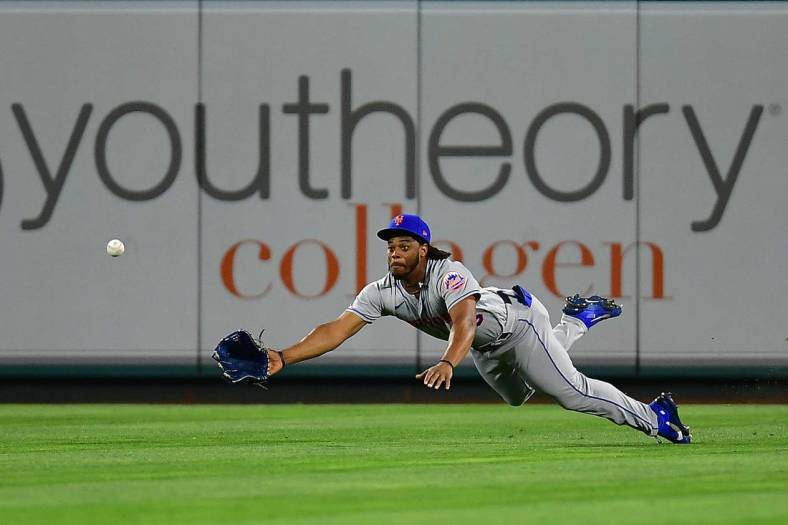 Jun 11, 2022; Anaheim, California, USA; New York Mets center fielder Khalil Lee (26) misses catching the two run RBI triple hit by Los Angeles Angels first baseman Jared Walsh (20) during the eighth inning at Angel Stadium. Mandatory Credit: Gary A. Vasquez-USA TODAY Sports