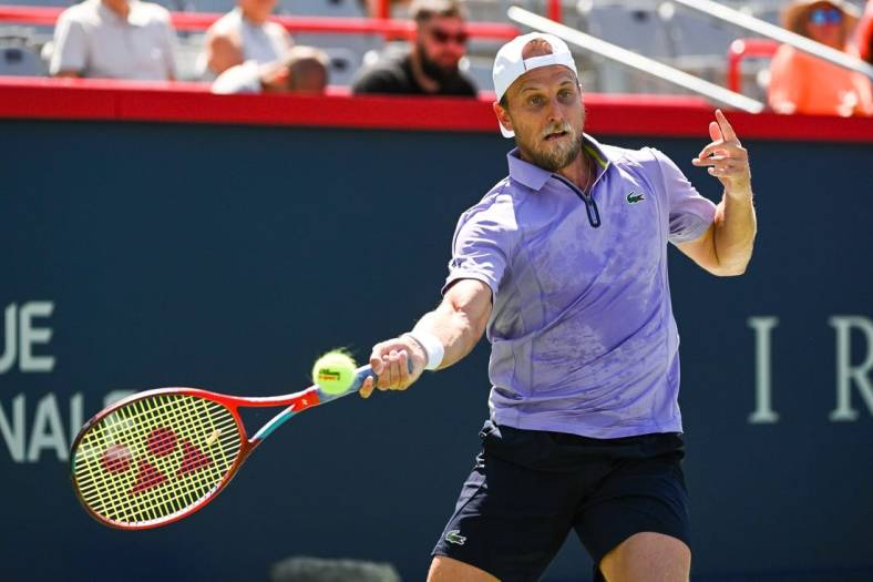 Aug 6, 2022; Montreal, Quebec, Canada; Denis Kudla (USA) hits a shot against Benoit Paire (FRA) (not pictured) in first round qualifying play at IGA Stadium. Mandatory Credit: David Kirouac-USA TODAY Sports
