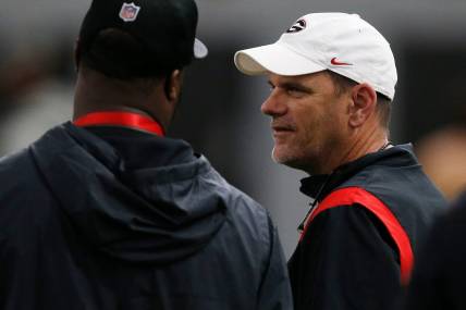 Georgia football analyst Mike Bobo speaks with an NFL scout during Georgia's Pro Day in Athens, Ga., on Wednesday, March 16, 2022.

Syndication Online Athens