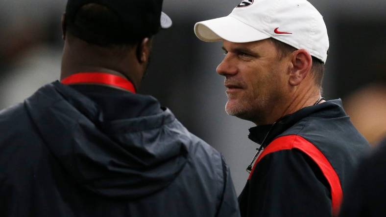 Georgia football analyst Mike Bobo speaks with an NFL scout during Georgia's Pro Day in Athens, Ga., on Wednesday, March 16, 2022.

Syndication Online Athens