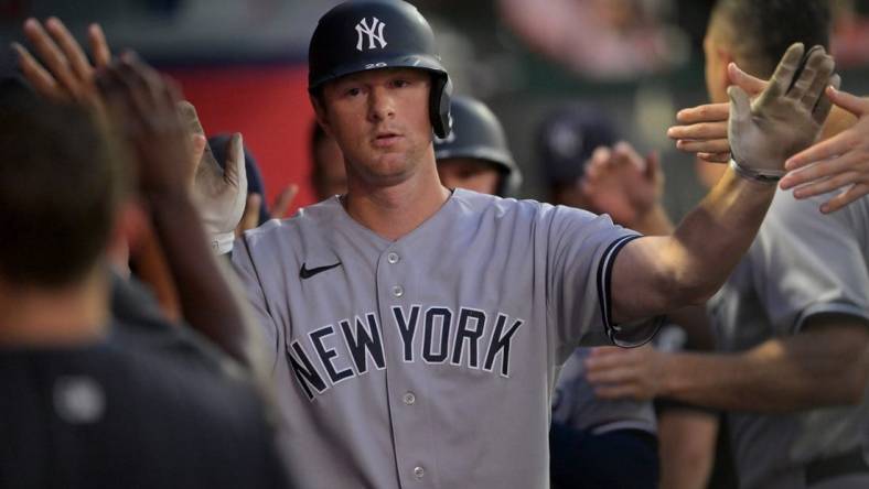 Aug 29, 2022; Anaheim, California, USA;  New York Yankees third baseman DJ LeMahieu (26) is greeted in the dugout after a sacrifice bunt scored a run in the fourth inning against the Los Angeles Angels at Angel Stadium. Mandatory Credit: Jayne Kamin-Oncea-USA TODAY Sports