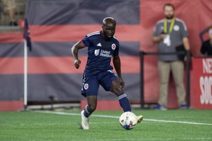 Aug 31, 2022; Foxborough, Massachusetts, USA; New England Revolution midfielder Emmanuel Boateng (11) passes the ball during the second half against the Chicago Fire FC at Gillette Stadium. Mandatory Credit: Paul Rutherford-USA TODAY Sports