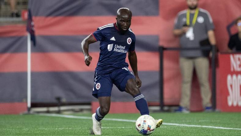 Aug 31, 2022; Foxborough, Massachusetts, USA; New England Revolution midfielder Emmanuel Boateng (11) passes the ball during the second half against the Chicago Fire FC at Gillette Stadium. Mandatory Credit: Paul Rutherford-USA TODAY Sports