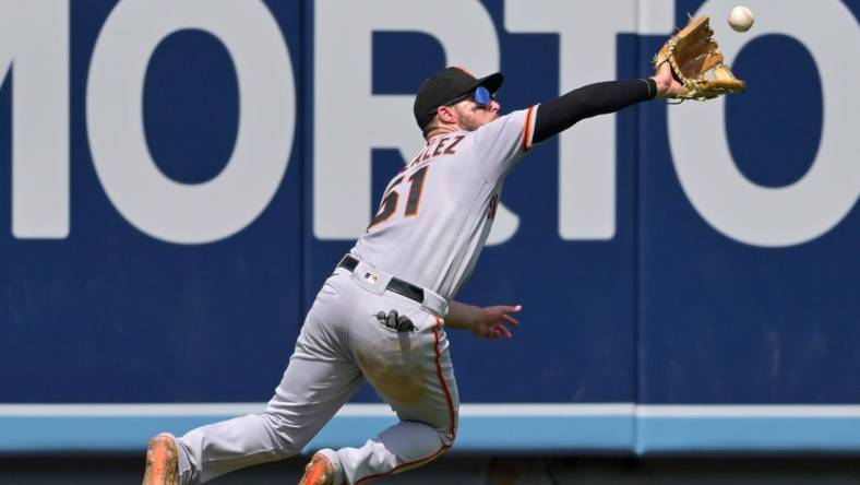 Sep 7, 2022; Los Angeles, California, USA;  San Francisco Giants right fielder Luis Gonzalez (51) makes a catch off a ball hit by Los Angeles Dodgers third baseman Miguel Vargas (not pictured) in the fourth inning at Dodger Stadium. Mandatory Credit: Jayne Kamin-Oncea-USA TODAY Sports