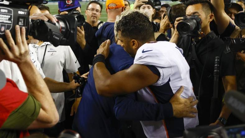 Sep 12, 2022; Seattle, Washington, USA; Denver Broncos quarterback Russell Wilson (3) hugs Seattle Seahawks head coach Pete Carroll following a 17-16 Seattle victory at Lumen Field. Mandatory Credit: Joe Nicholson-USA TODAY Sports