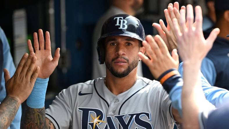 Sep 15, 2022; Toronto, Ontario, CAN;  Tampa Bay Rays left fielder David Peralta (6) celebrates in the dugout with team mates after scoring against the Toronto Blue Jays in the second inning at Rogers Centre. Mandatory Credit: Dan Hamilton-USA TODAY Sports