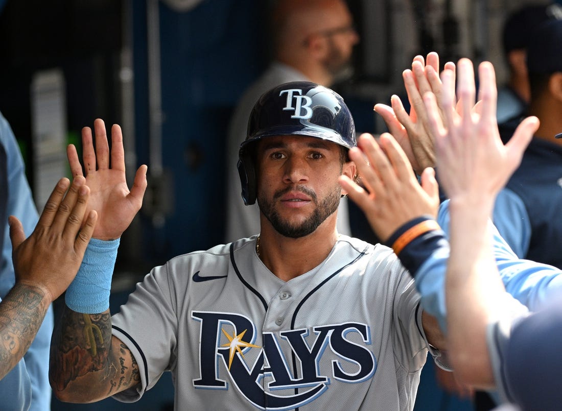 Sep 15, 2022; Toronto, Ontario, CAN;  Tampa Bay Rays left fielder David Peralta (6) celebrates in the dugout with team mates after scoring against the Toronto Blue Jays in the second inning at Rogers Centre. Mandatory Credit: Dan Hamilton-USA TODAY Sports