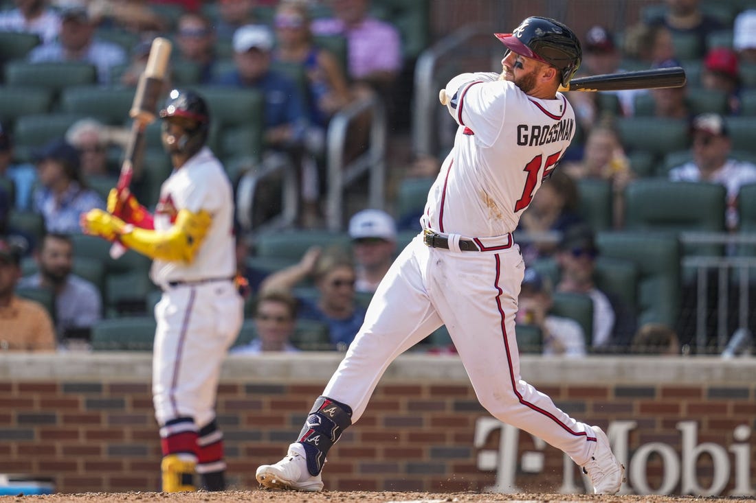 Sep 18, 2022; Cumberland, Georgia, USA; Atlanta Braves left fielder Robbie Grossman (15) hits a home run against the Philadelphia Phillies during the seventh inning at Truist Park. Mandatory Credit: Dale Zanine-USA TODAY Sports