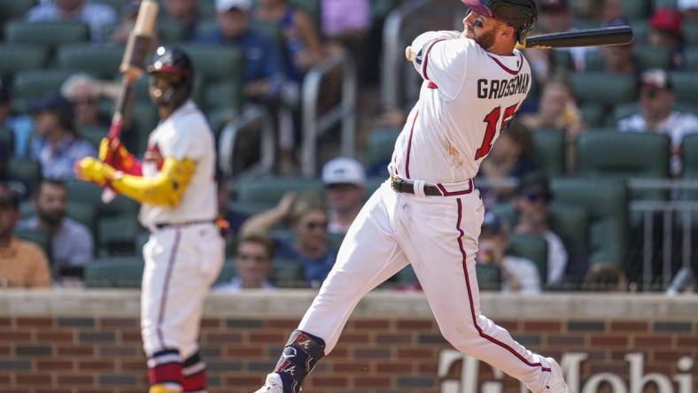 Sep 18, 2022; Cumberland, Georgia, USA; Atlanta Braves left fielder Robbie Grossman (15) hits a home run against the Philadelphia Phillies during the seventh inning at Truist Park. Mandatory Credit: Dale Zanine-USA TODAY Sports