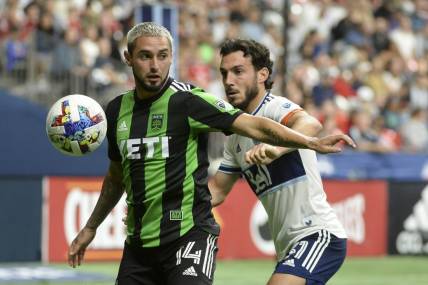 Oct 1, 2022; Vancouver, British Columbia, CAN;  Austin FC midfielder Diego Fagundez (14) takes possession of the ball against Vancouver Whitecaps FC forward Russell Teibert (31) during the second half at BC Place. Mandatory Credit: Anne-Marie Sorvin-USA TODAY Sports