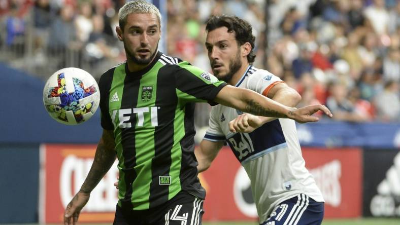 Oct 1, 2022; Vancouver, British Columbia, CAN;  Austin FC midfielder Diego Fagundez (14) takes possession of the ball against Vancouver Whitecaps FC forward Russell Teibert (31) during the second half at BC Place. Mandatory Credit: Anne-Marie Sorvin-USA TODAY Sports