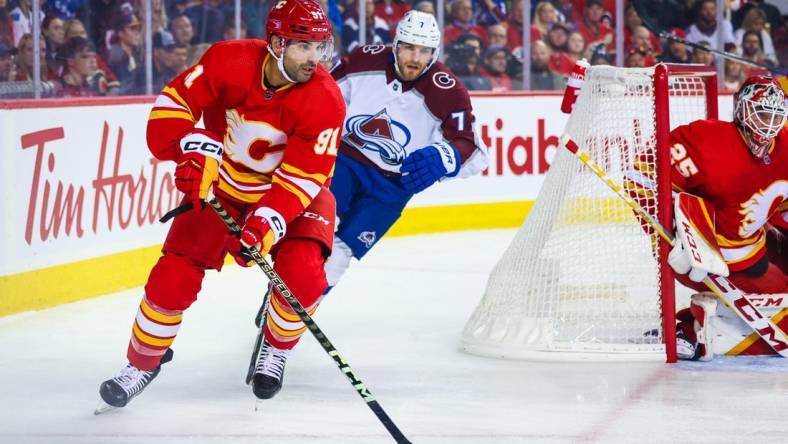 Oct 13, 2022; Calgary, Alberta, CAN; Calgary Flames center Nazem Kadri (91) controls the puck against the Colorado Avalanche during the first period at Scotiabank Saddledome. Mandatory Credit: Sergei Belski-USA TODAY Sports