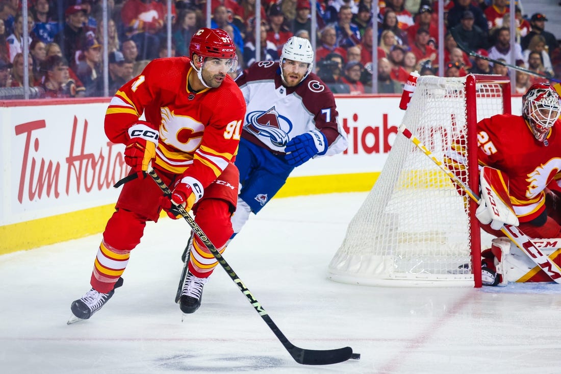 Oct 13, 2022; Calgary, Alberta, CAN; Calgary Flames center Nazem Kadri (91) controls the puck against the Colorado Avalanche during the first period at Scotiabank Saddledome. Mandatory Credit: Sergei Belski-USA TODAY Sports