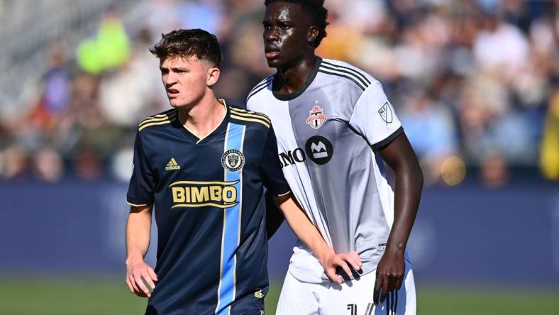 Oct 9, 2022; Philadelphia, Pennsylvania, USA; Philadelphia Union midfielder Jack Mcglynn (16) defends Toronto FC midfielder Noble Okello (14) in the first half at Subaru Park. Mandatory Credit: Kyle Ross-USA TODAY Sports