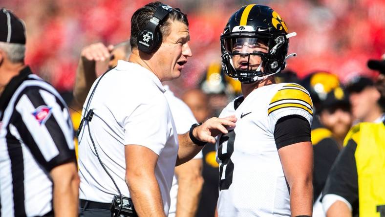 Iowa offensive coordinator and quarterbacks coach Brian Ferentz, left, talks with Iowa quarterback Alex Padilla (8) during a NCAA football game against Ohio State, Saturday, Oct. 22, 2022, at Ohio Stadium in Columbus, Ohio.

221022 Iowa Ohio St Fb 057 Jpg