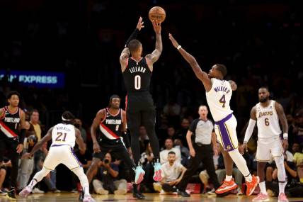 Oct 23, 2022; Los Angeles, California, USA;  Portland Trail Blazers guard Damian Lillard (0) shoots a three-pointer against Los Angeles Lakers guard Lonnie Walker IV (4) during the fourth quarter at Crypto.com Arena. Mandatory Credit: Kiyoshi Mio-USA TODAY Sports