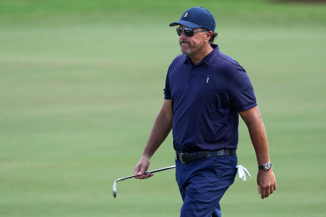 Oct 28, 2022; Miami, Florida, USA; Phil Mickelson walks up the fairway of the first hole during the first round of the season finale of the LIV Golf series at Trump National Doral. Mandatory Credit: Jasen Vinlove-USA TODAY Sports