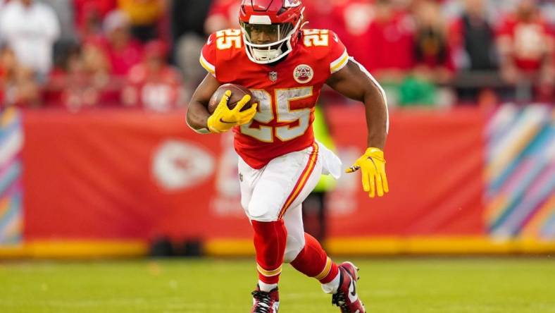 Oct 16, 2022; Kansas City, Missouri, USA; Kansas City Chiefs running back Clyde Edwards-Helaire (25) runs with the ball during the second half against the Buffalo Bills at GEHA Field at Arrowhead Stadium. Mandatory Credit: Jay Biggerstaff-USA TODAY Sports