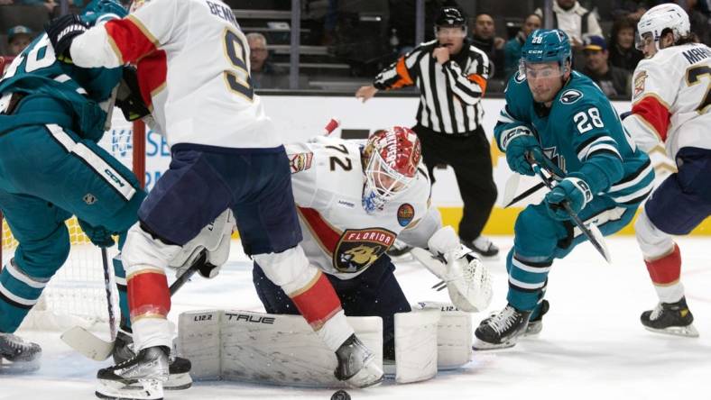 Nov 3, 2022; San Jose, California, USA; Florida Panthers goaltender Sergei Bobrovsky (72) deflects a shot by San Jose Sharks center Tomas Hertl (48) as Sharks right winger Timo Meier (28) reaches for the rebound during the second period at SAP Center at San Jose. Mandatory Credit: D. Ross Cameron-USA TODAY Sports