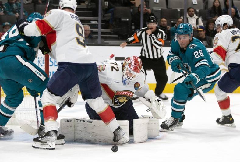 Nov 3, 2022; San Jose, California, USA; Florida Panthers goaltender Sergei Bobrovsky (72) deflects a shot by San Jose Sharks center Tomas Hertl (48) as Sharks right winger Timo Meier (28) reaches for the rebound during the second period at SAP Center at San Jose. Mandatory Credit: D. Ross Cameron-USA TODAY Sports