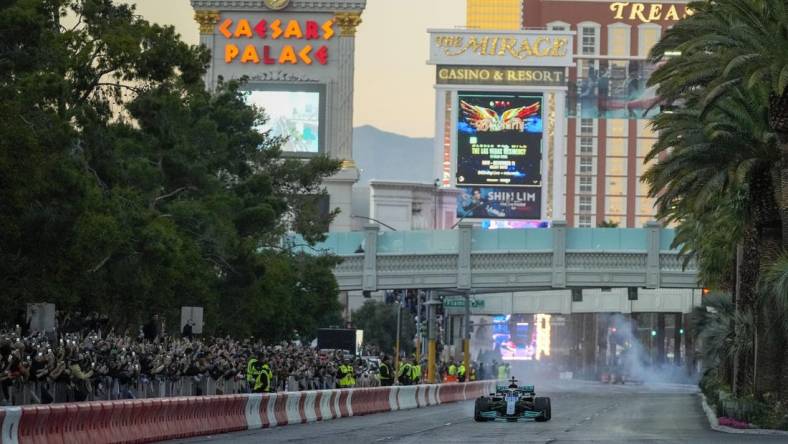 Nov 5, 2022; Las Vegas, Nevada, USA;  Mercedes-AMG Petronas driver George Russell drives on the track during the Formula One Las Vegas Grand Prix Launch Party at Las Vegas Strip. Mandatory Credit: Ray Acevedo-USA TODAY Sports