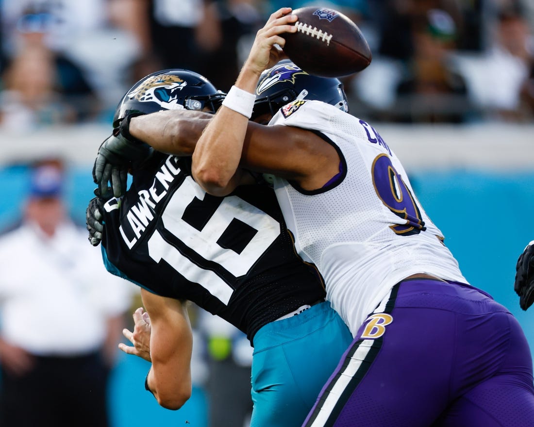 Nov 27, 2022; Jacksonville, Florida, USA; Baltimore Ravens defensive tackle Calais Campbell (93) sacks Jacksonville Jaguars quarterback Trevor Lawrence (16) during the fourth quarter at TIAA Bank Field. Mandatory Credit: Douglas DeFelice-USA TODAY Sports