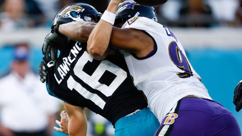 Nov 27, 2022; Jacksonville, Florida, USA; Baltimore Ravens defensive tackle Calais Campbell (93) sacks Jacksonville Jaguars quarterback Trevor Lawrence (16) during the fourth quarter at TIAA Bank Field. Mandatory Credit: Douglas DeFelice-USA TODAY Sports