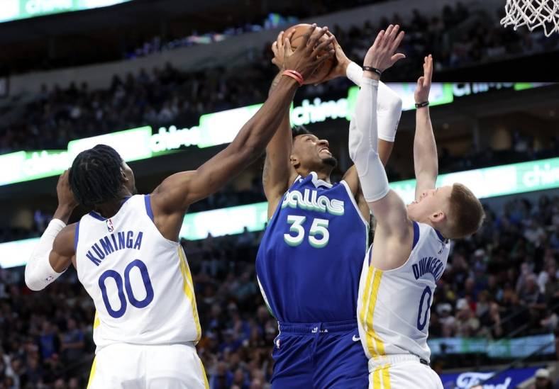 Nov 29, 2022; Dallas, Texas, USA;  Dallas Mavericks center Christian Wood (35) shoots as Golden State Warriors forward Jonathan Kuminga (00) and Golden State Warriors guard Donte DiVincenzo (0) defends during the second half at American Airlines Center. Mandatory Credit: Kevin Jairaj-USA TODAY Sports