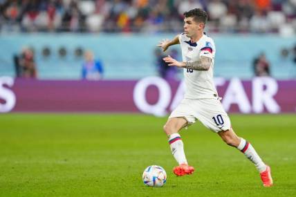 Dec 3, 2022; Al Rayyan, Qatar; United States of America forward Christian Pulisic (10) dribbles the ball against the Netherlands during the second half of a round of sixteen match in the 2022 FIFA World Cup at Khalifa International Stadium. Mandatory Credit: Danielle Parhizkaran-USA TODAY Sports