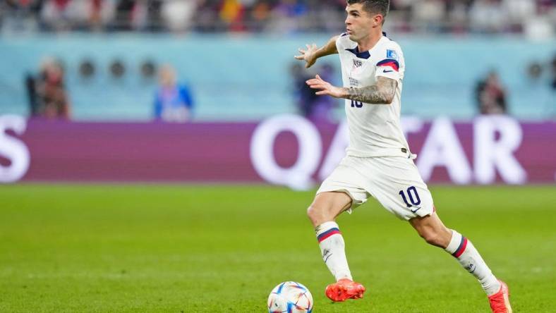 Dec 3, 2022; Al Rayyan, Qatar; United States of America forward Christian Pulisic (10) dribbles the ball against the Netherlands during the second half of a round of sixteen match in the 2022 FIFA World Cup at Khalifa International Stadium. Mandatory Credit: Danielle Parhizkaran-USA TODAY Sports