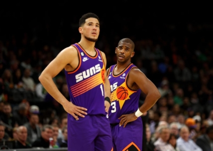 Dec 7, 2022; Phoenix, Arizona, USA; Phoenix Suns guard Devin Booker (1) and Chris Paul (3) against the Boston Celtics at Footprint Center. Mandatory Credit: Mark J. Rebilas-USA TODAY Sports