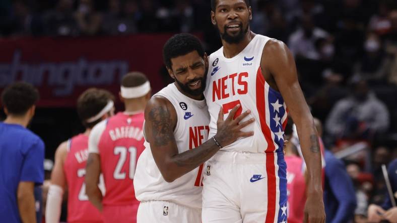 Dec 12, 2022; Washington, District of Columbia, USA; Brooklyn Nets guard Kyrie Irving (11) celebrates with Nets forward Kevin Durant (7) against the Washington Wizards in the fourth quarter at Capital One Arena. Mandatory Credit: Geoff Burke-USA TODAY Sports