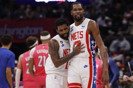 Dec 12, 2022; Washington, District of Columbia, USA; Brooklyn Nets guard Kyrie Irving (11) celebrates with Nets forward Kevin Durant (7) against the Washington Wizards in the fourth quarter at Capital One Arena. Mandatory Credit: Geoff Burke-USA TODAY Sports